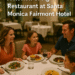 Smiling family of four dining at Fig Restaurant inside the Fairmont Hotel Santa Monica, enjoying salads, pasta, and steak.