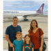 Family of four posing in front of a Hawaiian Airlines airplane before flying from Los Angeles to Oahu.