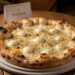 Freshly baked white pizza with mozzarella and black pepper at Pizzana restaurant in Los Angeles.
