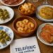 Spanish tapas spread with shrimp, jamón, patatas bravas, tortilla española, olives, and wine at Teleféric Los Angeles.