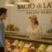 Customer ordering gelato at Bacio di Latte in Brentwood, Los Angeles, with colorful flavors displayed in the case.