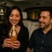 Couple on a Waymo date night sharing a chimney cone ice cream outside AJA Vineyards Tasting Room in Santa Monica.