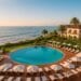 Panoramic view of Orange County’s luxury coastline with oceanfront resorts and palm trees at sunset, representing five-star resorts like Ritz-Carlton Laguna Niguel and Montage Laguna Beach.