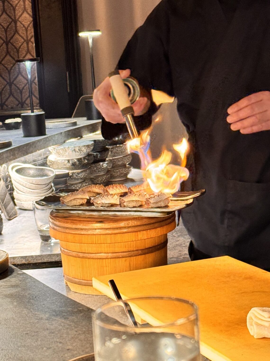 Chef torching a tray of nigiri at the counter during our TAIKUN omakase dinner at the Ritz-Carlton, Laguna Niguel