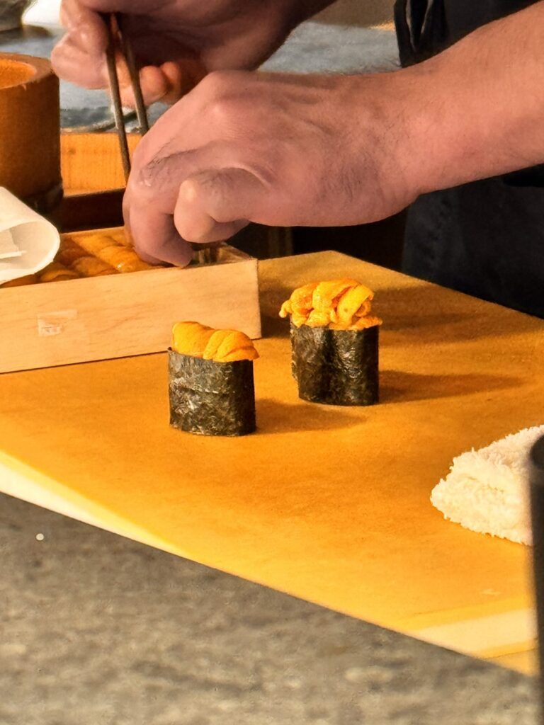 Chef preparing Hokkaido uni gunkan nigiri at the TAIKUN counter