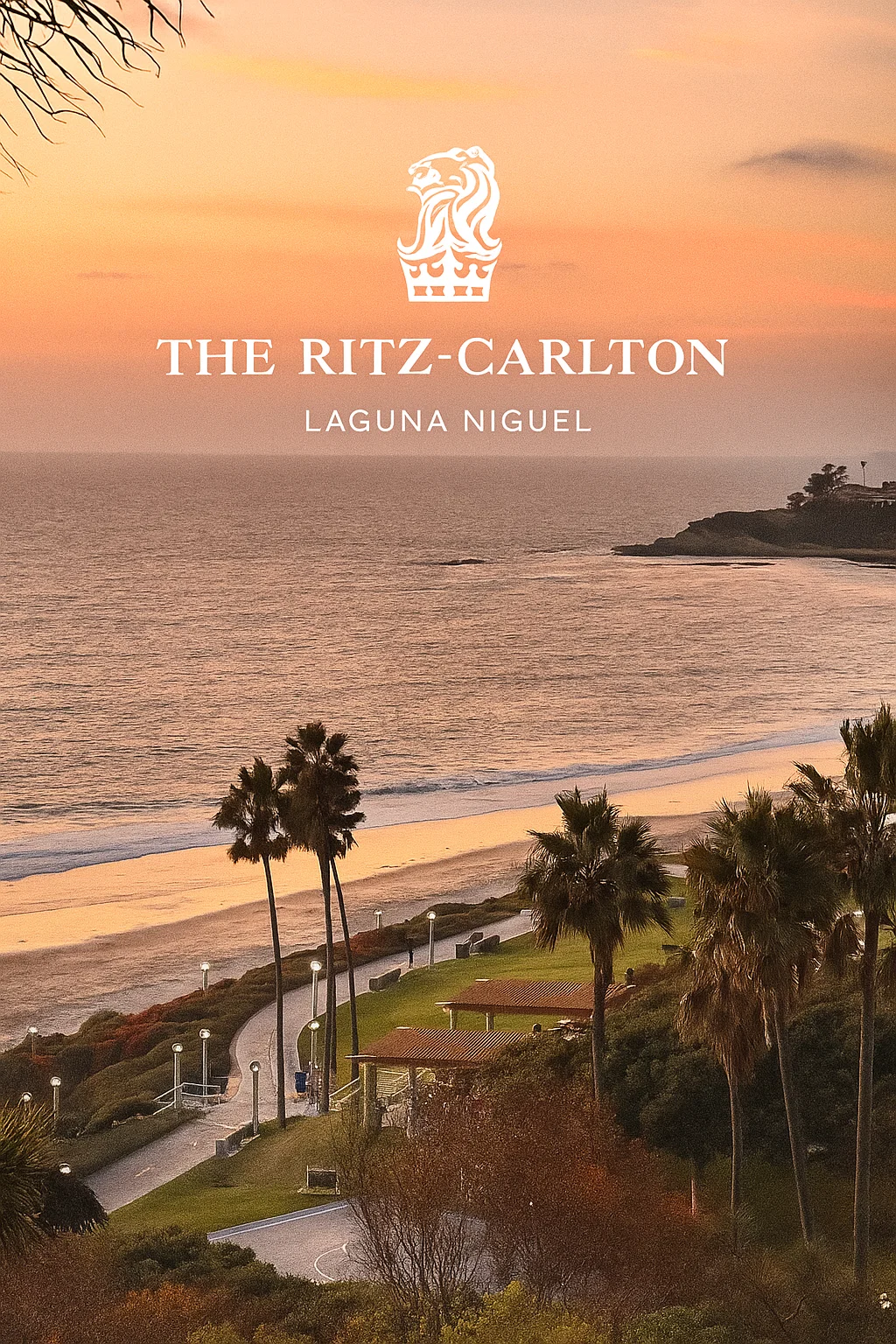 An elevated view of the Laguna Niguel coastline at sunset. A winding coastal path, lined with tall palm trees and green spaces, follows the edge of a sandy beach. The Pacific Ocean is calm, and the sky glows with soft orange and pink colors. The Ritz-Carlton, Laguna Niguel logo is in the bottom right corner.