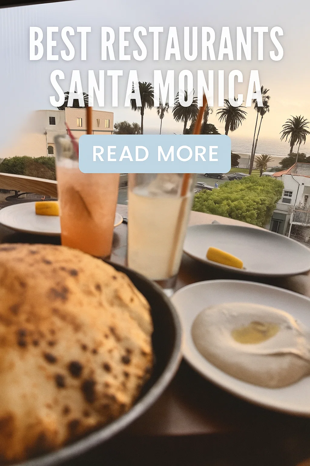 A top-down view of a table with two cocktails, flatbread, and a bowl of hummus, overlooking the Santa Monica coast with palm trees at sunset. White text reads "BEST RESTAURANTS SANTA MONICA" and a light blue button says "READ MORE".