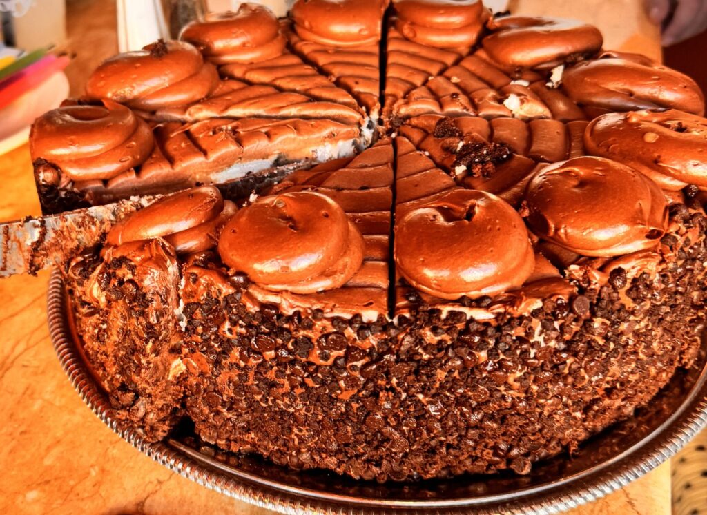 A whole Oreo Cookie Cheesecake topped with chocolate frosting swirls at The Cheesecake Factory in Santa Monica, a culinary highlight of our weekend