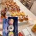 A vibrant display of luxury donuts and cruffins at Donutique in The Venetian Las Vegas, featuring gold-leaf accents, fresh berries, and artisan glazes on a marble counter.