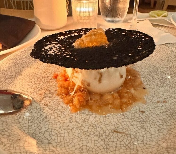 A high-end dessert and cocktail on a white textured plate at a Los Angeles restaurant, featuring a Pinterest-style text overlay for an inKind app guide.