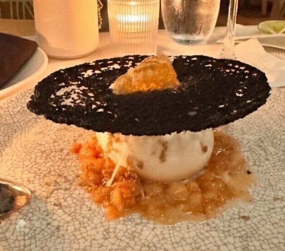 A high-end dessert and cocktail on a white textured plate at a Los Angeles restaurant, featuring a Pinterest-style text overlay for an inKind app guide.