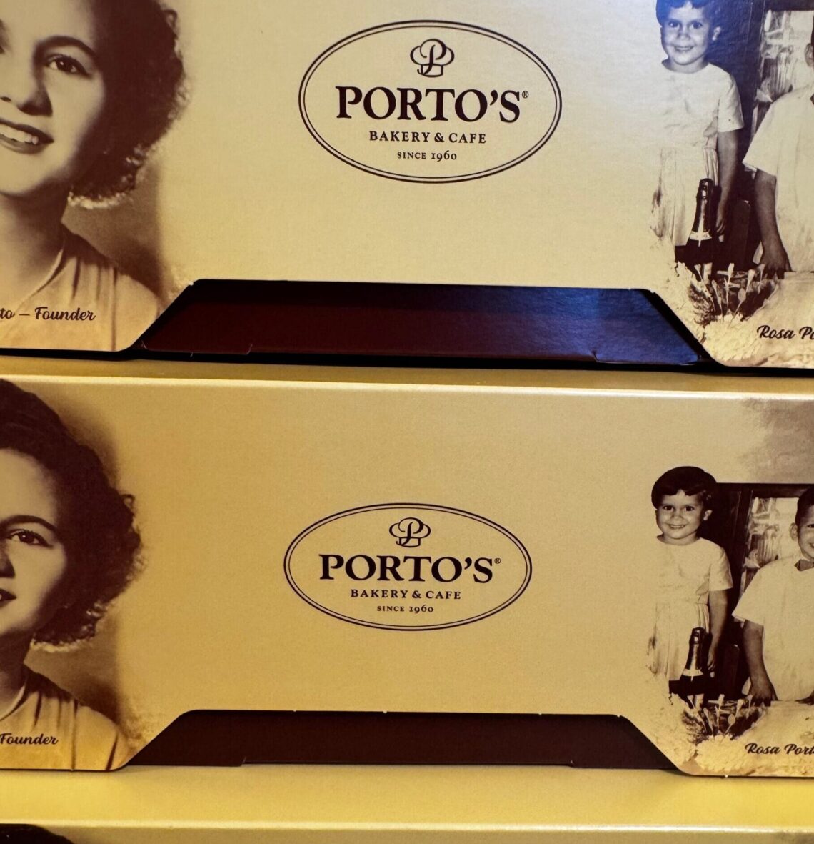 Close-up of yellow Porto’s Bakery & Cafe boxes featuring a vintage black and white portrait of founder Rosa Porto and her children.