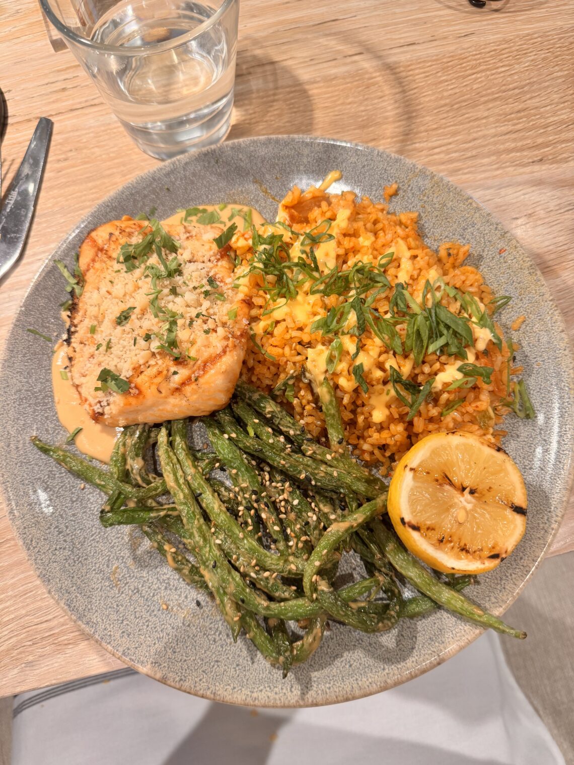 Macadamia crusted salmon, sesame green beans, and kimchi fried rice at Pacific Catch, a solid inKind app pick in Los Angeles.