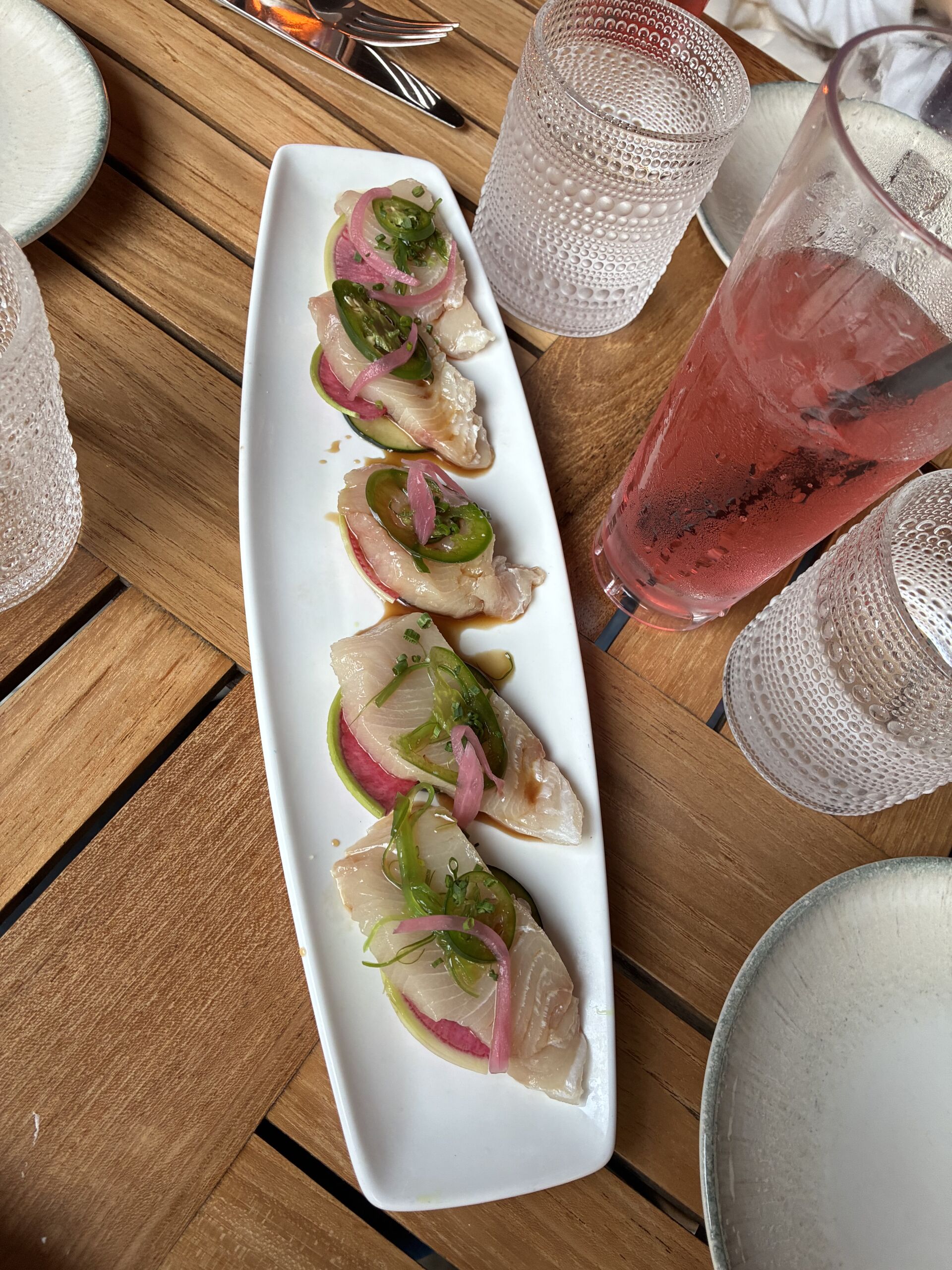 Yellowtail crudo with ginger ponzu, Persian cucumber, watermelon radish, pickled red onion, and serrano peppers at Shoreside Restaurant and Bar in Santa Monica