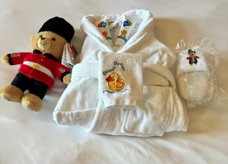 Kid-sized bathrobe, slippers, toiletries, and a London guard teddy bear from the Very Important Kids program