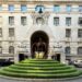 The entrance courtyard of the London Marriott Hotel County Hall, featuring a tiered circular green lawn and sculptural centerpiece in front of the hotel’s ornate stone façade.