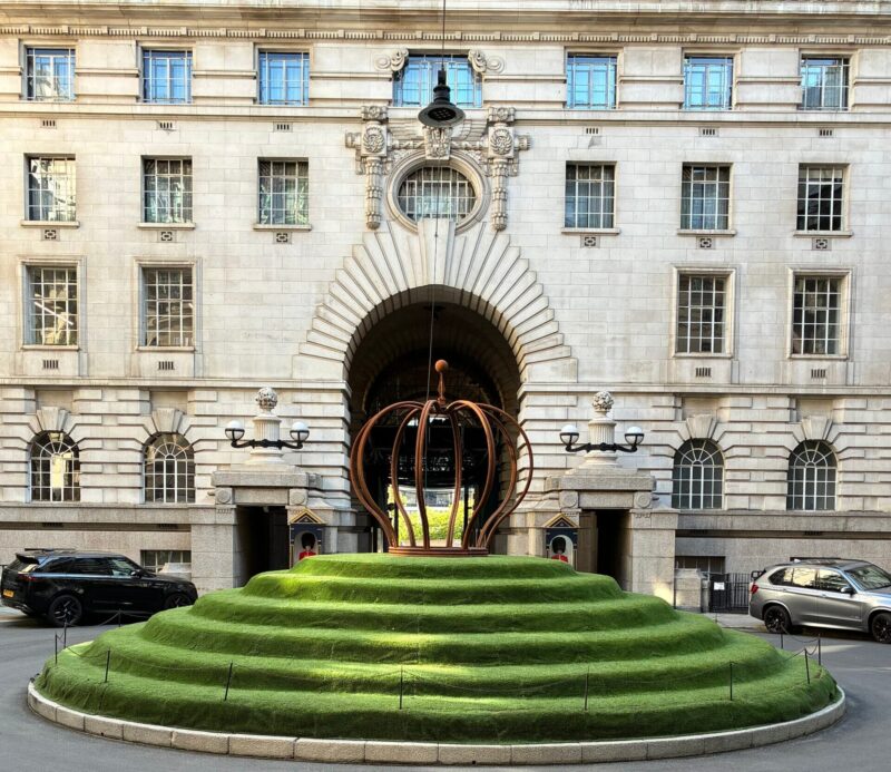 Entrance courtyard of the London Marriott County Hall with its tiered lawn and crown sculpture
