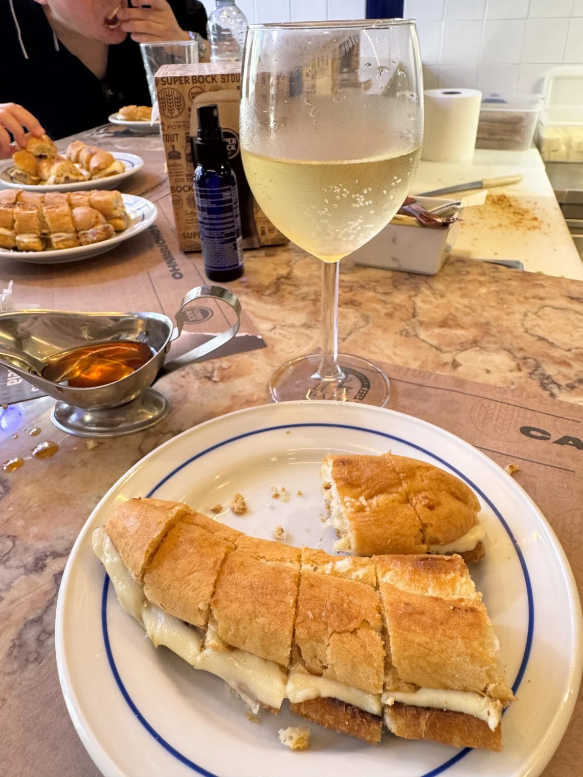 Cachorrinho hot dog sandwich with a glass of Espadal Vinho Verde at Cervejaria Gazela in Porto