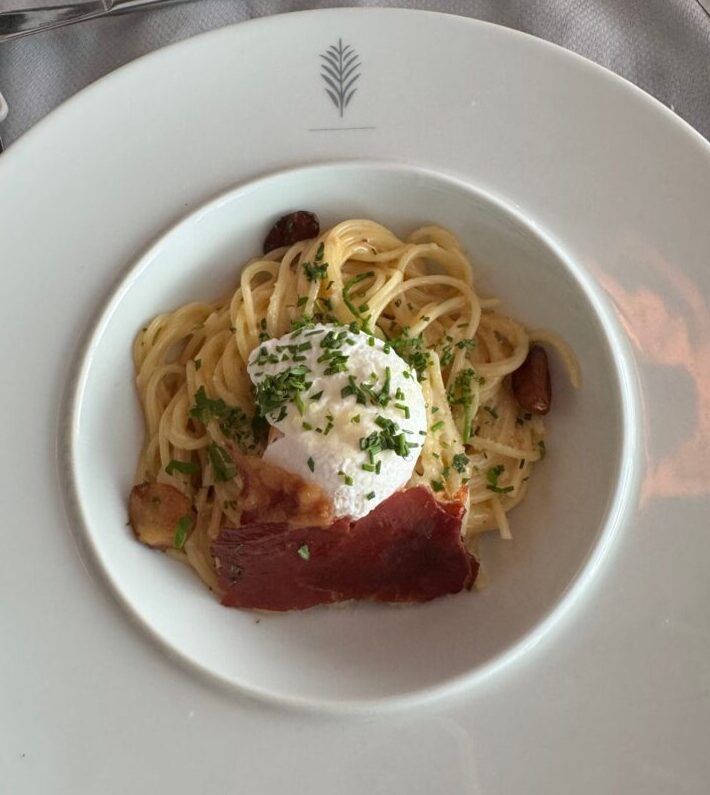Pasta with a poached egg at Luminae, the restaurant in The Retreat on Celebrity Apex