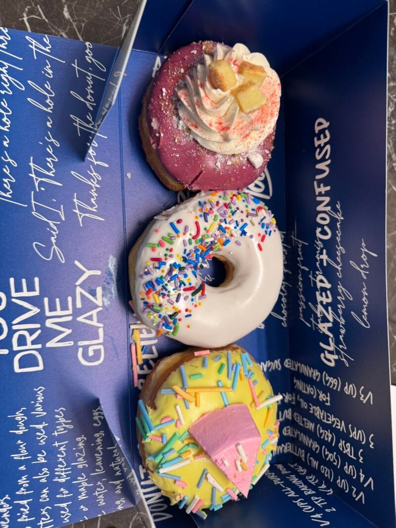 Donut order from Donutique in the Grand Canal Shoppes at The Venetian Resort in Las Vegas, including the Sprinkle Donut, the Birthday Cake Donut, and the Strawberry Cheesecake Donut