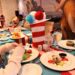 Dr. Seuss Thing 1 and Thing 2 Birthday Breakfast spread on Carnival Firenze, with Green Eggs and Ham, Who-Ville Red Velvet French Toast, and Grinch's Pancakes