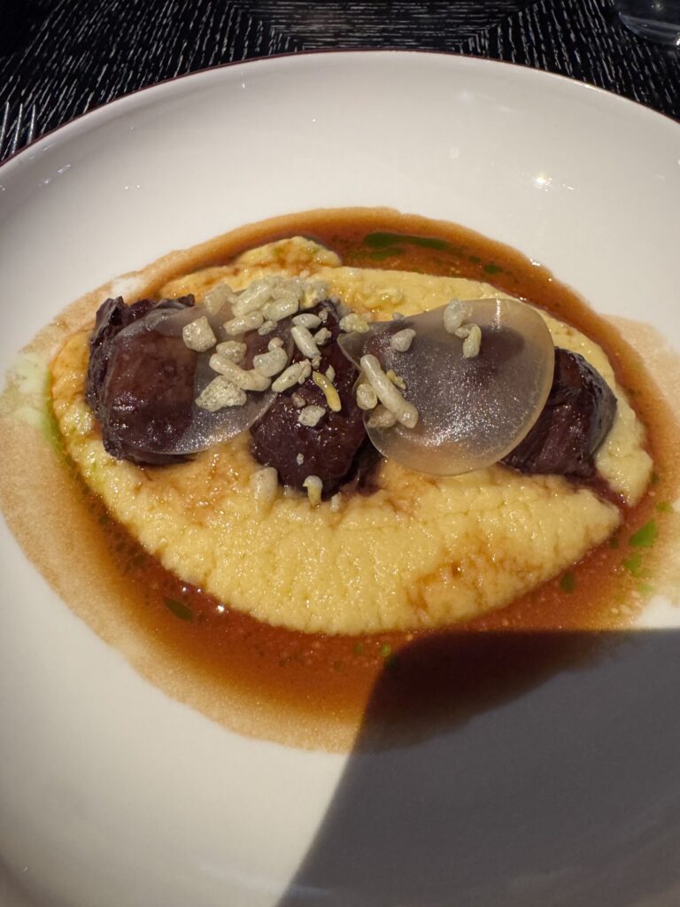 Glazed pork cheeks with creamed polenta and pickled apple at Indigo at One Aldwych