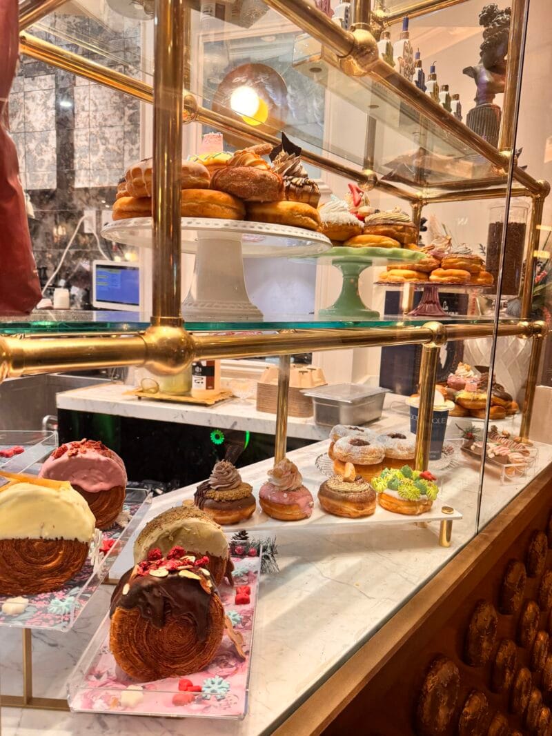 Display case of donut creations at Donutique in the Grand Canal Shoppes at The Venetian Resort in Las Vegas, including classic donuts, filled donuts, and cronuts