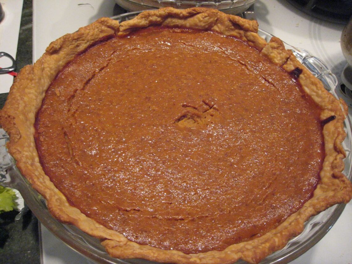 A homemade pumpkin pie with a fork-crimped crust, made ahead for Thanksgiving
