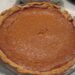 A homemade pumpkin pie with a fork-crimped crust, made ahead for Thanksgiving