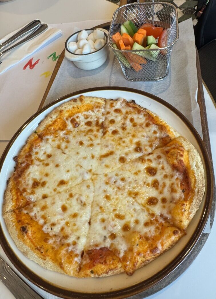 Kids' Cheese Pizza served with a side of veggies and marshmallows at Cafe Landwer in Brentwood.