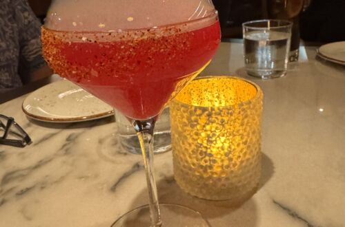 A vibrant La Flaca cocktail served at Telefèric Barcelona restaurant in Brentwood, showcasing its colorful presentation.