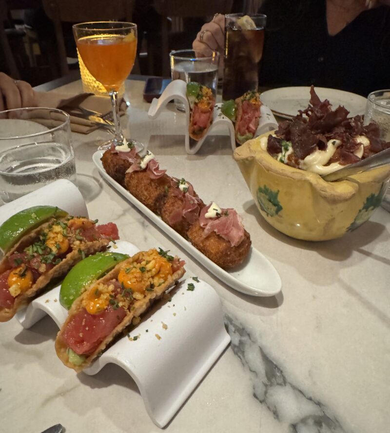 A tempting display of Patatas Bravas, Ham Croquetas, and Tuna Tacos served at Telefèric Barcelona in Brentwood.