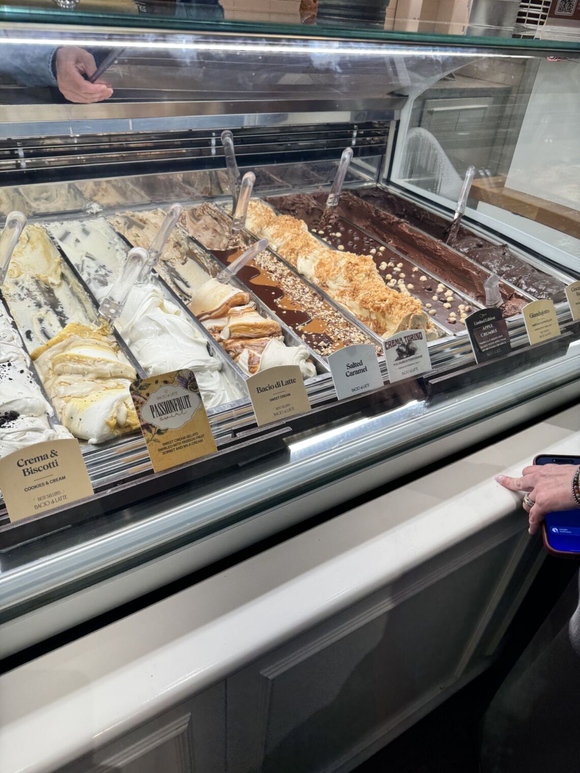 A vibrant view of Bacio di Latte gelato shop in Brentwood, LA, showcasing an assortment of colorful gelato flavors and inviting decor.