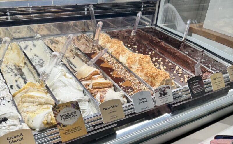 A vibrant view of Bacio di Latte gelato shop in Brentwood, LA, showcasing an assortment of colorful gelato flavors and inviting decor.