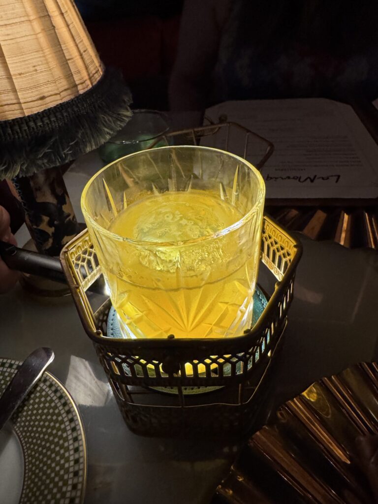 Furansu cocktail, a golden drink in a crystal glass set in an ornate gold holder
