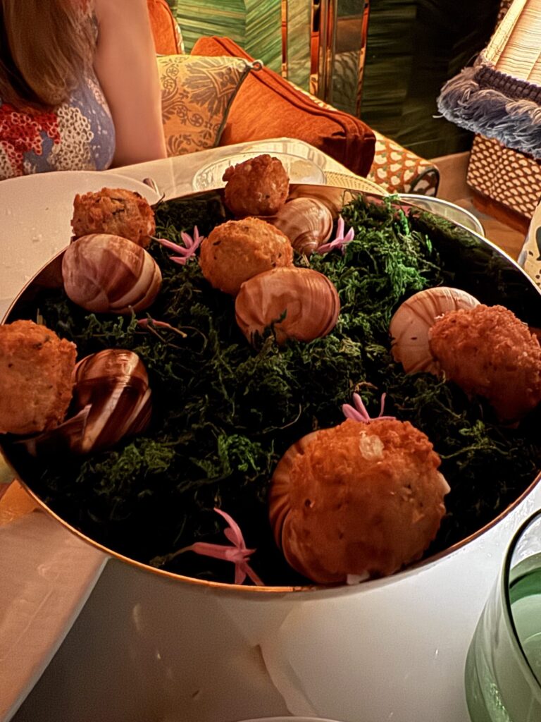 Escargot poppers at La Monique Santa Monica, served in snail shells on a bed of moss