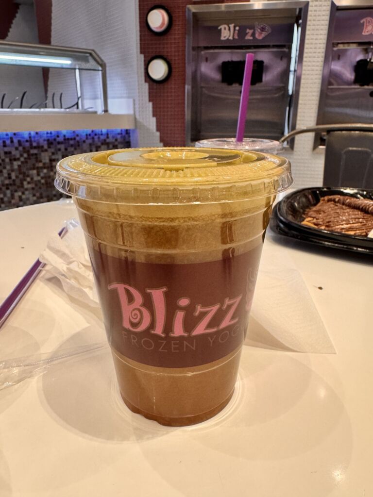 A smoothie in a plastic cup with a pink straw from Blizz Frozen Yogurt at the MGM Grand
