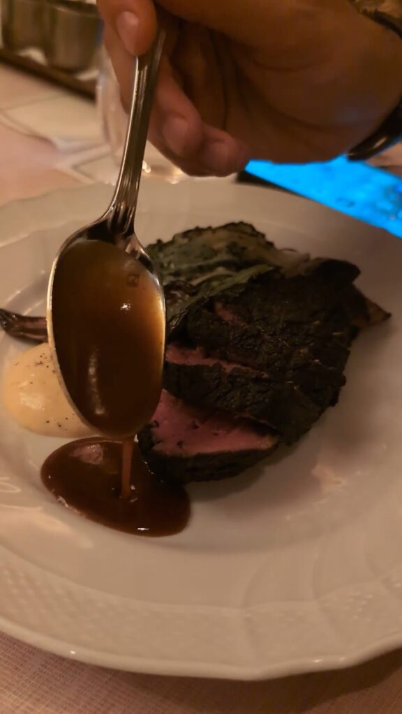 Sauce poured tableside over filet mignon with Penja pepper sabayon at Muse Santa Monica