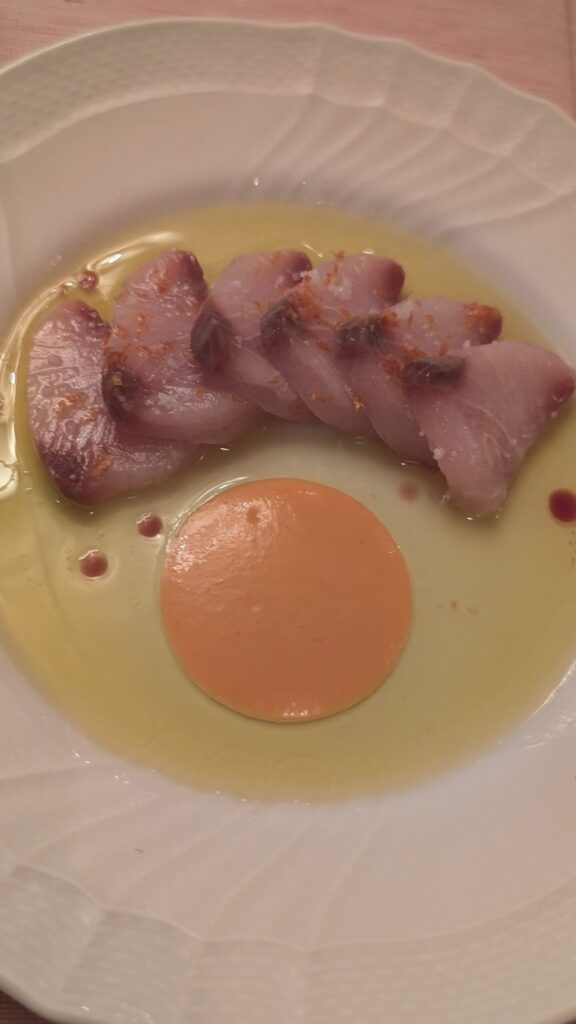Hamachi with yuzu olive oil and Calabrian chili coulis at Muse Santa Monica