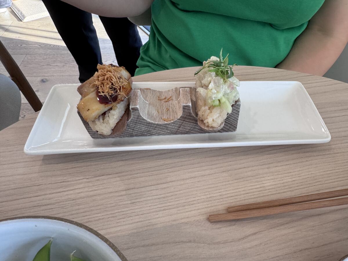 Pork belly and poke hand rolls on a white plate