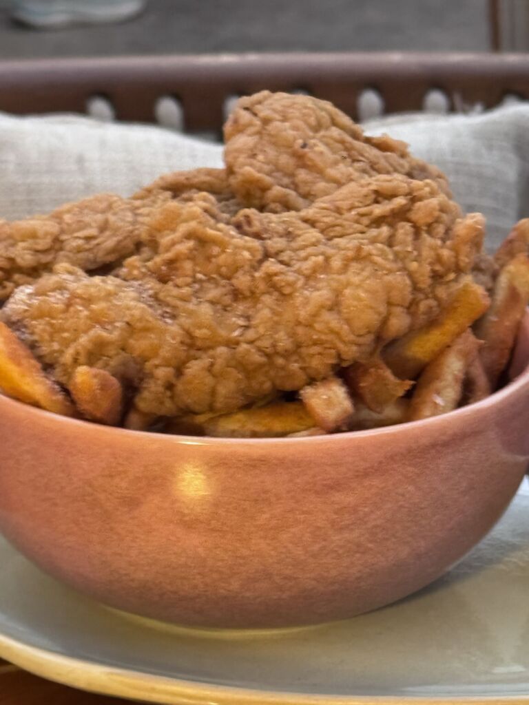 A pink bowl of crispy chicken fingers and fries from the kids’ menu at Marelle in Santa Monica
