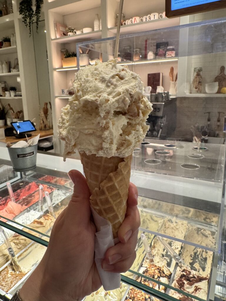 Gelato in a waffle cone at the counter at Bacio di Latte