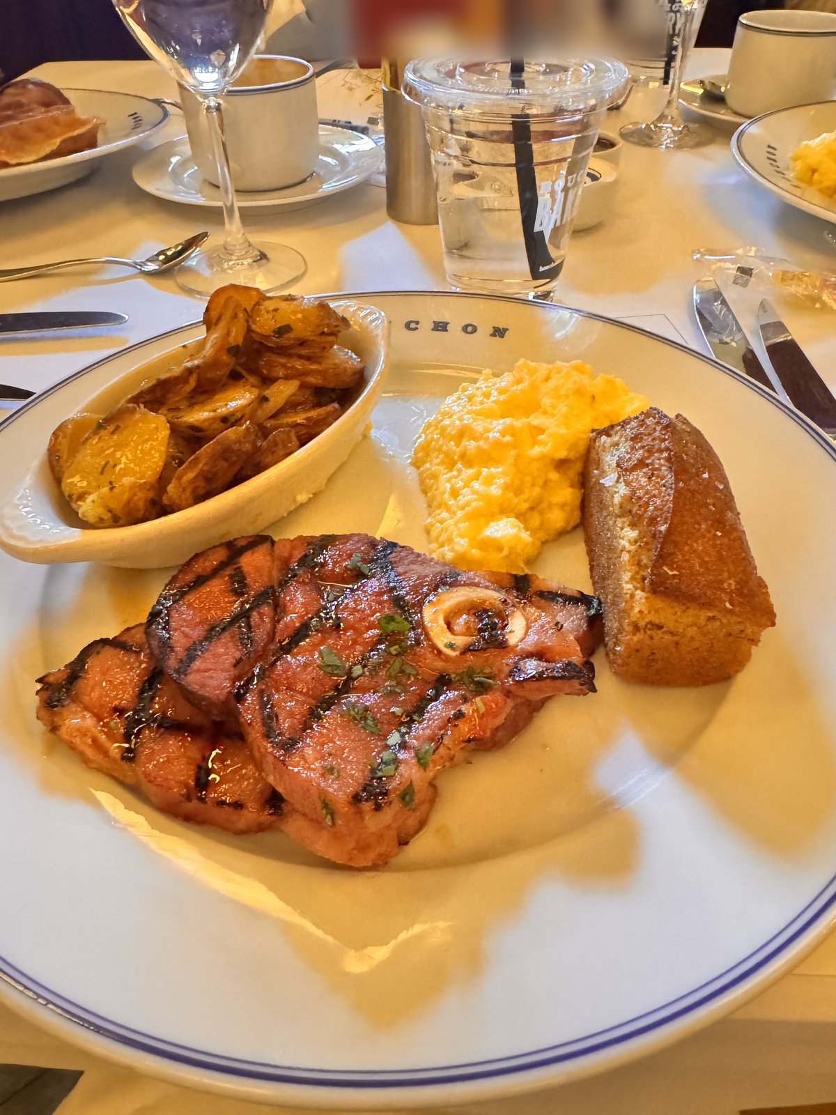 Grilled ham steak with scrambled eggs, potatoes and a cornbread loaf at Bouchon in The Venetian