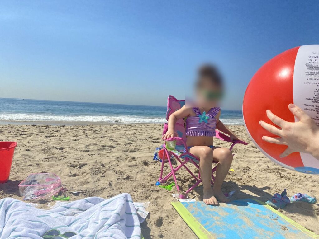 Child in a beach chair at Crystal Cove State Beach