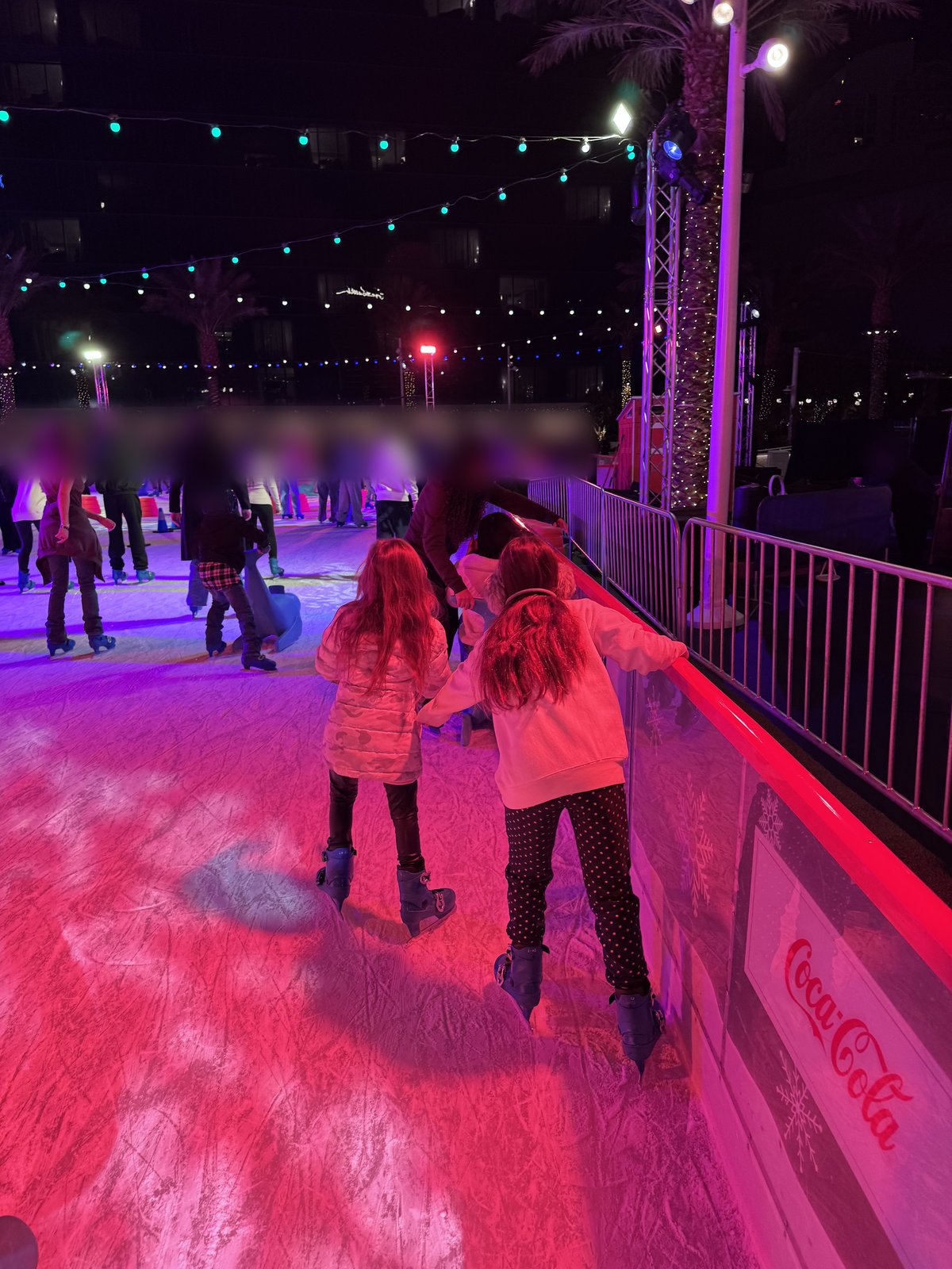 Our daughters skating along the rail at the Fontainebleau Las Vegas ice rink