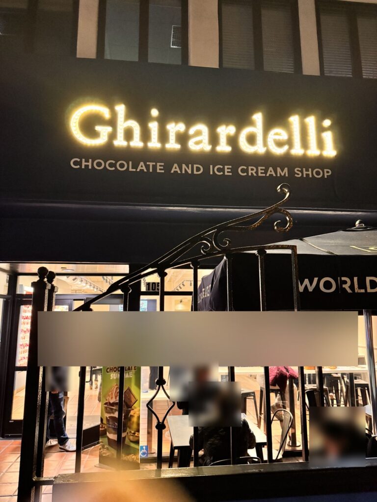 Ghirardelli Chocolate and Ice Cream Shop storefront in Santa Monica at night