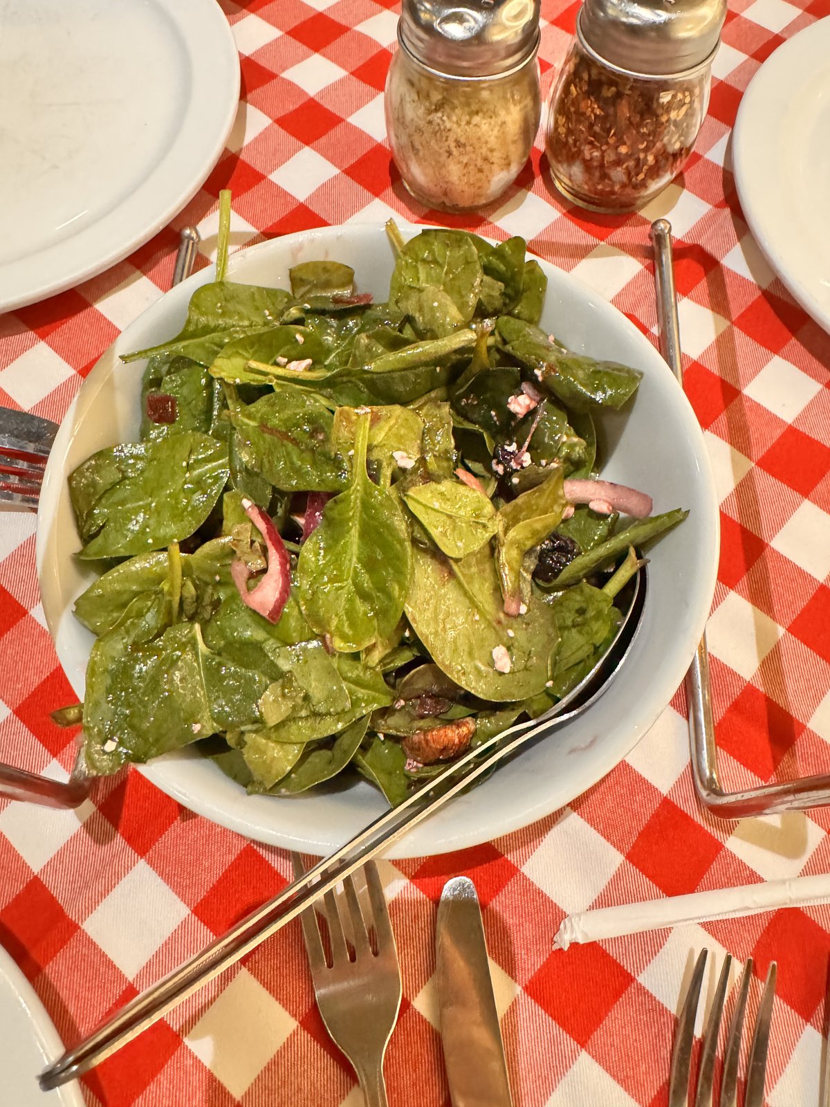 Cherry Pecan Salad with spinach on a red checkered tablecloth at Grimaldi’s in The Venetian