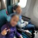 Two kids in Hawaiian Airlines economy seats on the 787