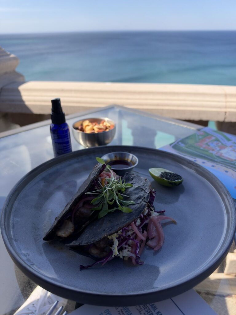 Surf and turf tacos on blue corn tortillas with slaw and pickled onions at 180blu