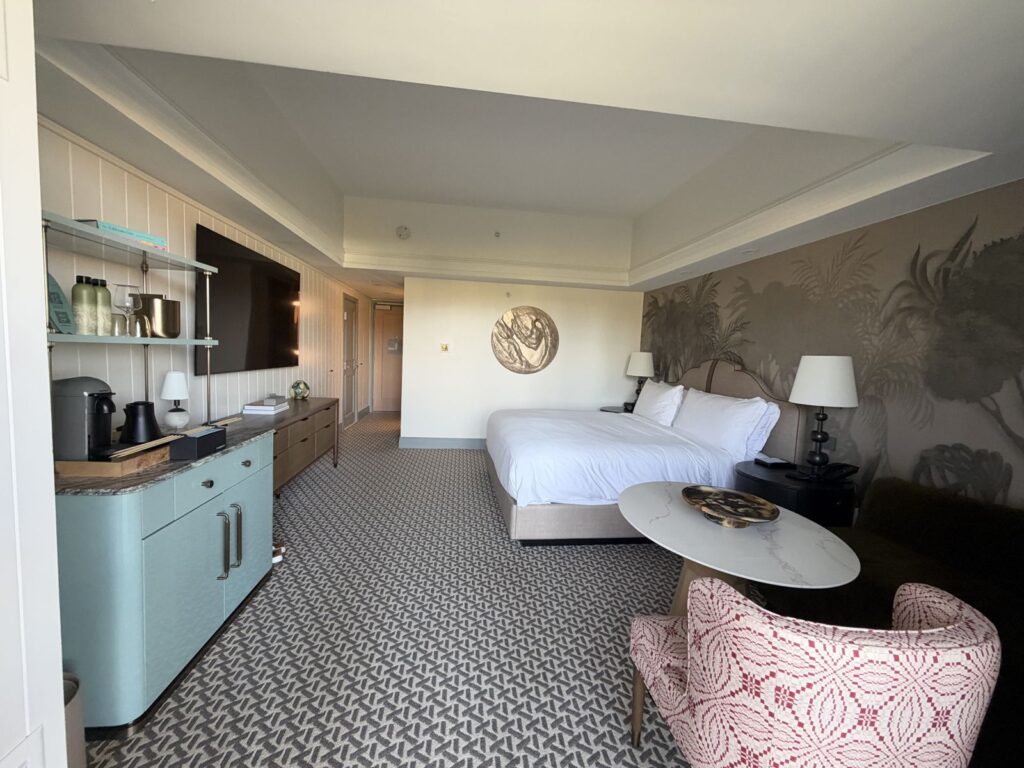 Fire pit guest room at the Ritz-Carlton Laguna Niguel with king bed, palm mural and green coffee bar